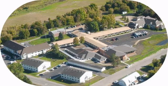 Aerial view of West View Assisted Living facility showing multiple connected buildings with parking lots, surrounded by trees and greenery.