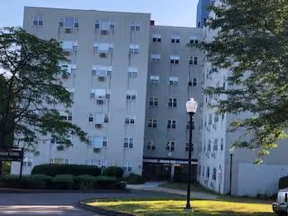 Front view of Nottingham Tower, showcasing the building's exterior with multiple windows and a landscaped entrance.