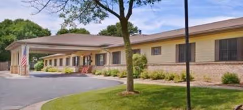 Single-story Brookdale Sun Prairie facility with a covered entrance and landscaped front yard.
