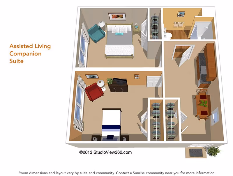 3D floor plan of an Assisted Living Companion Suite showing two bedrooms, two closets, a bathroom, and a combined kitchen and dining area. The bedrooms each have a bed, chair, and dresser. The kitchen includes cabinets, a stove, and a dining table with chairs. There is a small entryway with a plant near the entrance.