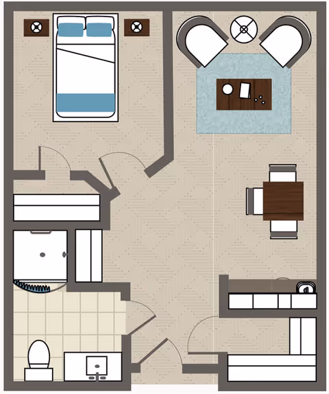 Floor plan of a senior living unit featuring a bedroom with a double bed and two nightstands, a living area with two armchairs and a coffee table on a rug, a dining area with a table and four chairs, a kitchen with cabinets and a sink, and a bathroom with a toilet, sink, and shower.