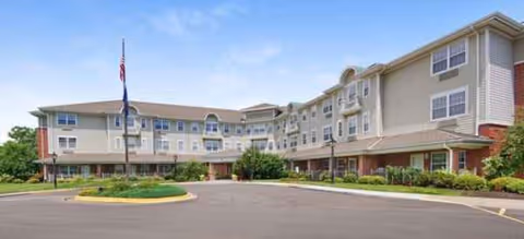 Exterior view of Pegasus Landing of Overland Park, a senior living facility with a circular drive.