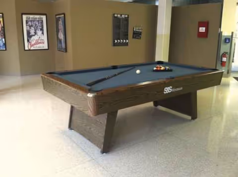 Indoor recreation area with a pool table in a senior living facility.