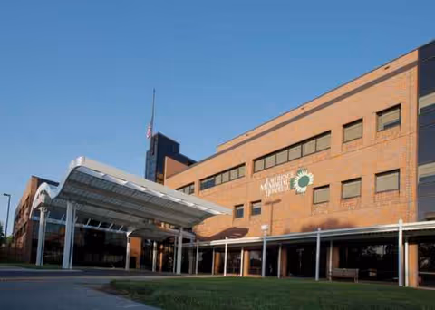 Exterior view of Lawrence Memorial Hospital with brick facade and glass-covered entrance canopy.