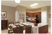 A modern kitchen and dining area with wooden cabinets, stainless steel appliances, and a white countertop island. The dining table is set with plates and cutlery, and there are framed pictures on the walls.