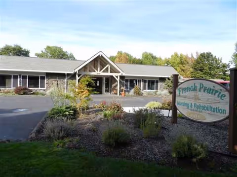Single-story nursing facility exterior with a front sign reading French Prairie Nursing and Rehabilitation Center.