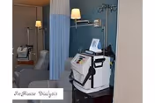 Interior treatment area with dialysis machines, reclining chairs, and privacy curtains.