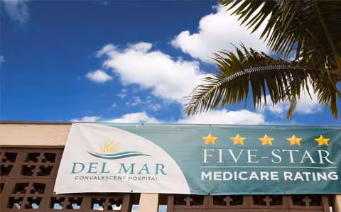 Outdoor view of Del Mar Convalescent Hospital banner on the building front.