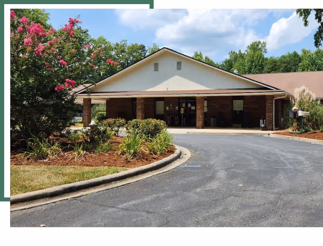 Front view of Asheboro Rehabilitation and Healthcare Center entrance with curved driveway and landscaping.