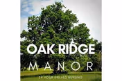 Outdoor view of Oak Ridge Manor logo with a large tree against a blue sky.
