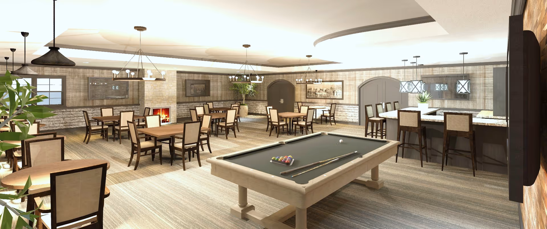 A spacious common area with a pool table in the foreground, several wooden tables and chairs arranged throughout the room, a fireplace with a fire burning, and a bar area with high chairs and pendant lighting. The room has a warm, inviting atmosphere with neutral tones and decorative plants.