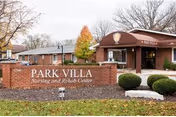 Front view of Park Villa Nursing and Rehab Center entrance with brick sign.