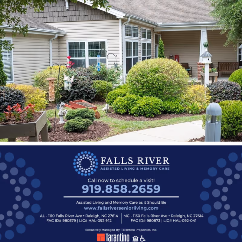 Landscaped courtyard and entrance of Falls River Village assisted living with shrubs, birdhouses, and a promotional banner at the bottom.