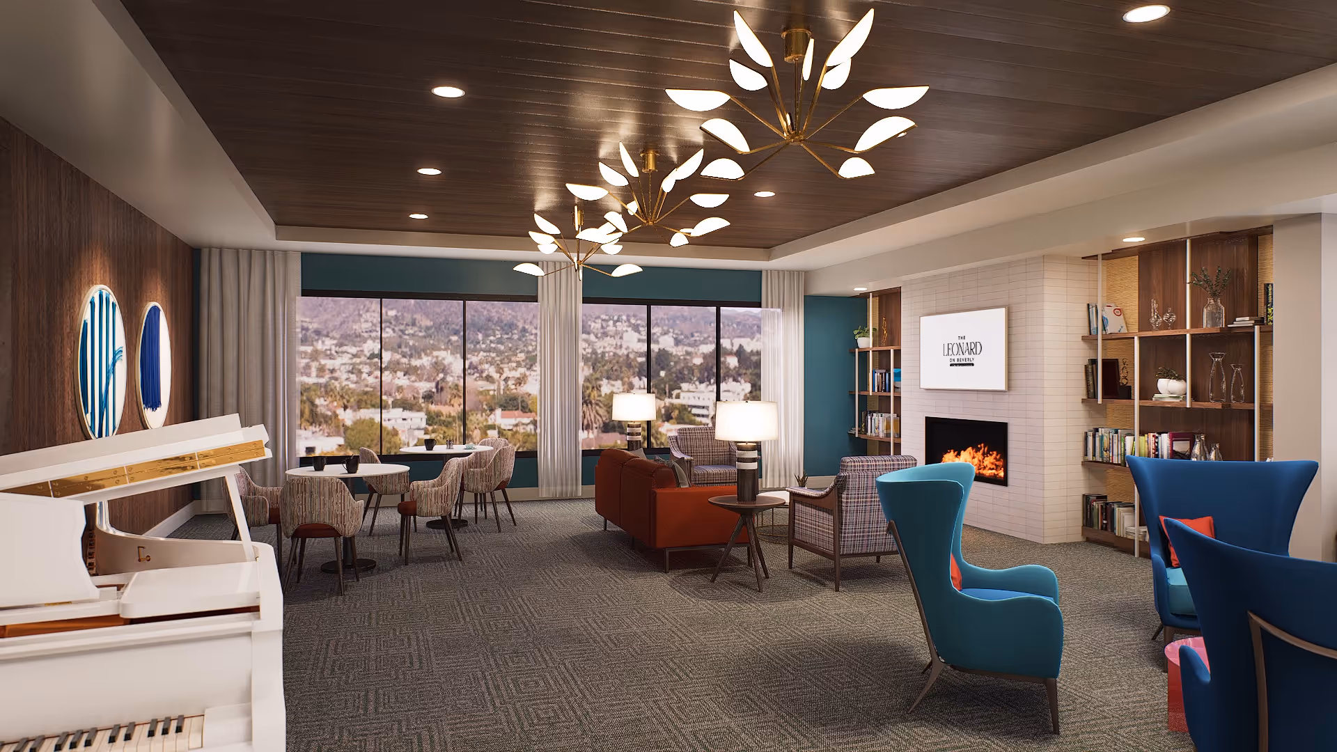 A spacious and well-lit living room area with modern furniture including blue armchairs, a red sofa, and patterned chairs. There is a white piano on the left side, round tables with chairs near large windows showing a cityscape view. The room features a fireplace with a TV above it displaying 'The Leonard on Beverly,' built-in bookshelves, and decorative ceiling lights resembling leaves.
