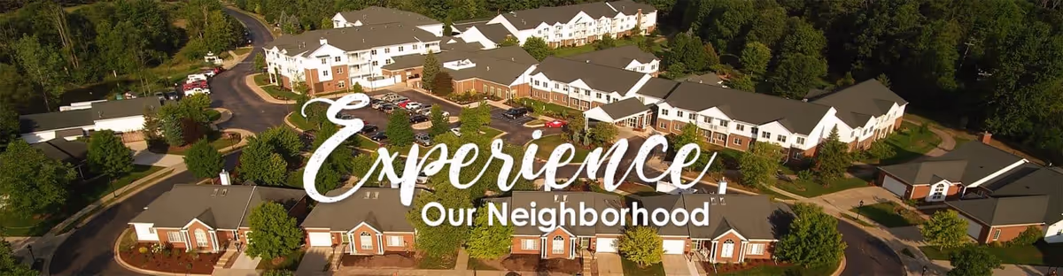 Aerial view of The Meadows at Silver Maples senior living campus with multiple buildings, driveways, and surrounding trees.