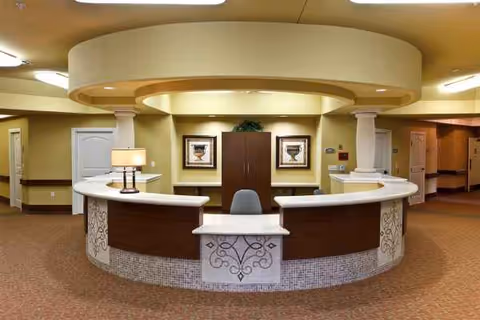 Circular reception desk in Villa Toscana at Cypress Woods lobby.