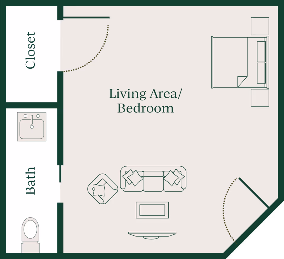 Floor plan of a living area/bedroom with a bed, two nightstands, a sofa with two pillows, an armchair, a coffee table, and a TV. There is a closet and a bathroom with a sink and toilet adjacent to the living area/bedroom.