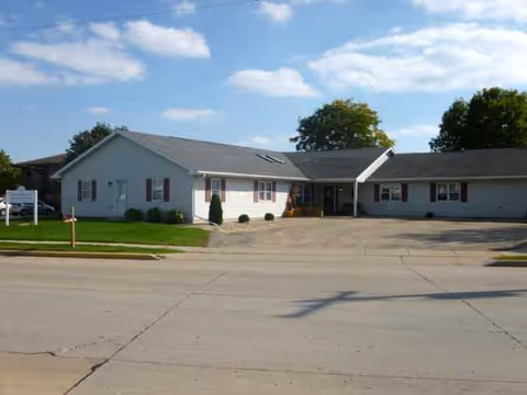 Care Partners Assisted Living building, a single-story facility with a sloped roof and parking lot.
