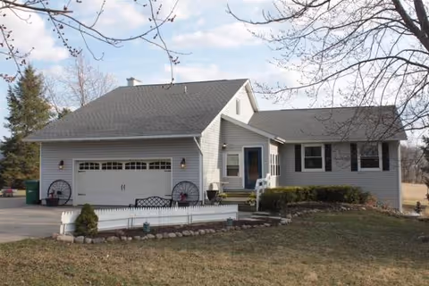 A single-story gray house with a two-car garage and front entrance.