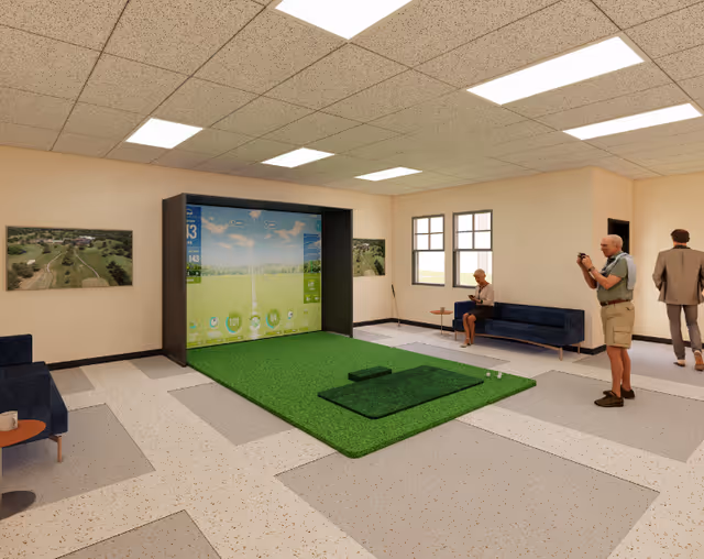 Indoor room with a golf simulator setup featuring a green turf mat and a large screen displaying a golf course. Three elderly people are present: one sitting on a blue couch, one standing and holding a golf club, and another walking away. The room has beige walls, ceiling lights, framed landscape pictures, and windows letting in natural light.