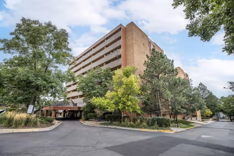 Brookdale Tamarac Square exterior: brick, multi-story senior living building with trees and entrance.