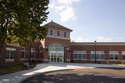 Exterior of Chateau Girardeau senior living facility with entrance and trees.