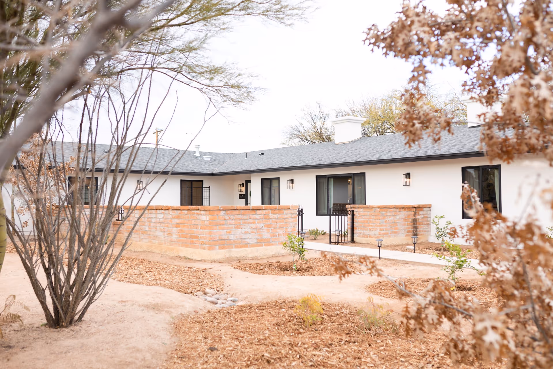 Heritage Oaks Assisted Living building exterior with brick walls and a desert landscaping courtyard.