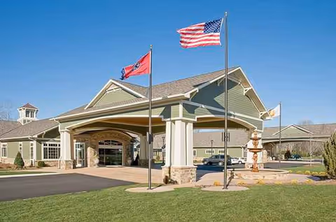 Front entrance of Life Care Center of Ooltewah with flags and a circular driveway.