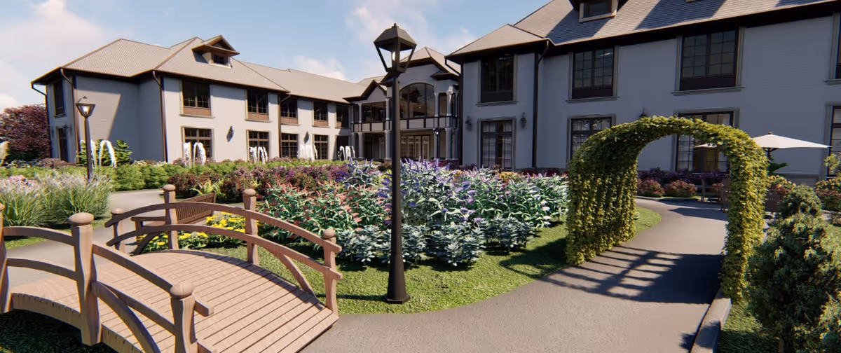 Landscaped courtyard with a wooden footbridge, arched trellis, and a multi-story building facade in the background.