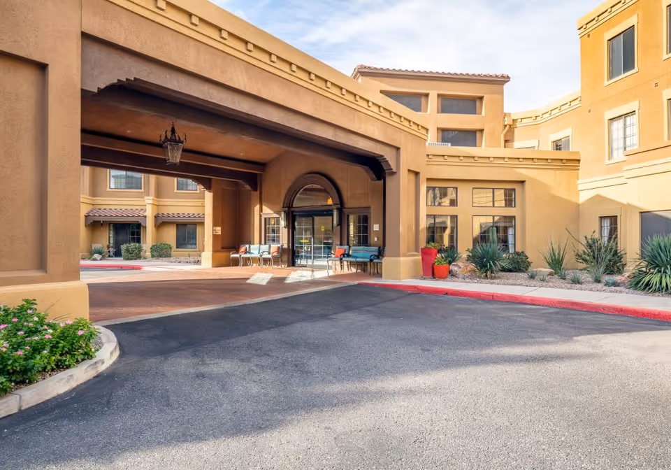 Entrance to Fairwinds - Desert Point senior living facility with covered drive and landscaping.