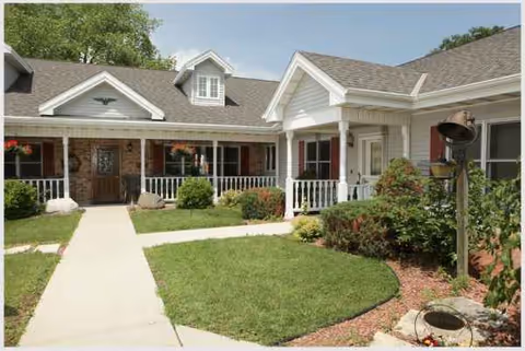 Front view of Frontida Assisted Living: Liberty House with manicured lawn and walkway.