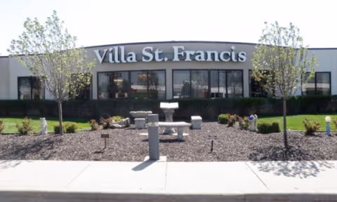 Exterior view of Villa St. Francis Catholic Care Center with landscaped entry.