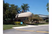 Exterior view of Springwood Center entrance with a rounded canopy and landscaping.