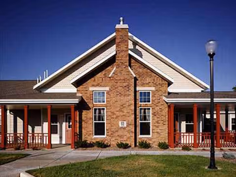 Front exterior of Sylvan Crossings at Westshire, brick facade and columned entrance.