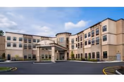 Exterior view of Pine Valley Center with covered entrance and surrounding parking lot.