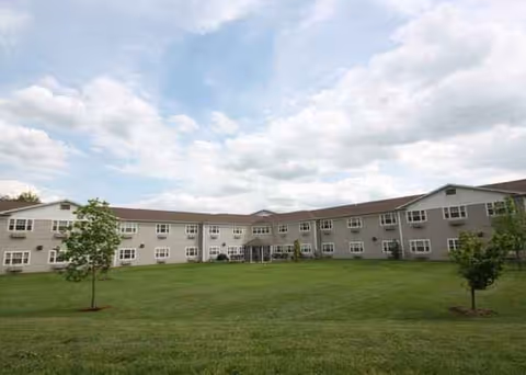Heritage Woods of Benton exterior: long building with green lawn and small trees.