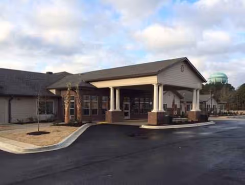 Front entrance of Colonial Gardens Assisted Living & Memory Care facility with porte-cochere.