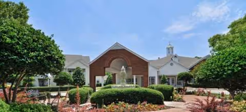 Exterior view of Brookdale Chambrel Williamsburg front entrance with fountain and landscaped garden.
