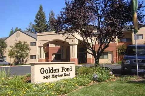 Front exterior of Golden Pond Retirement Community with its sign and landscaping.