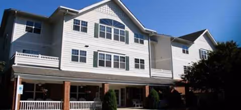 Brookdale Meadowmont exterior: white multi-story senior living building with a covered entrance.