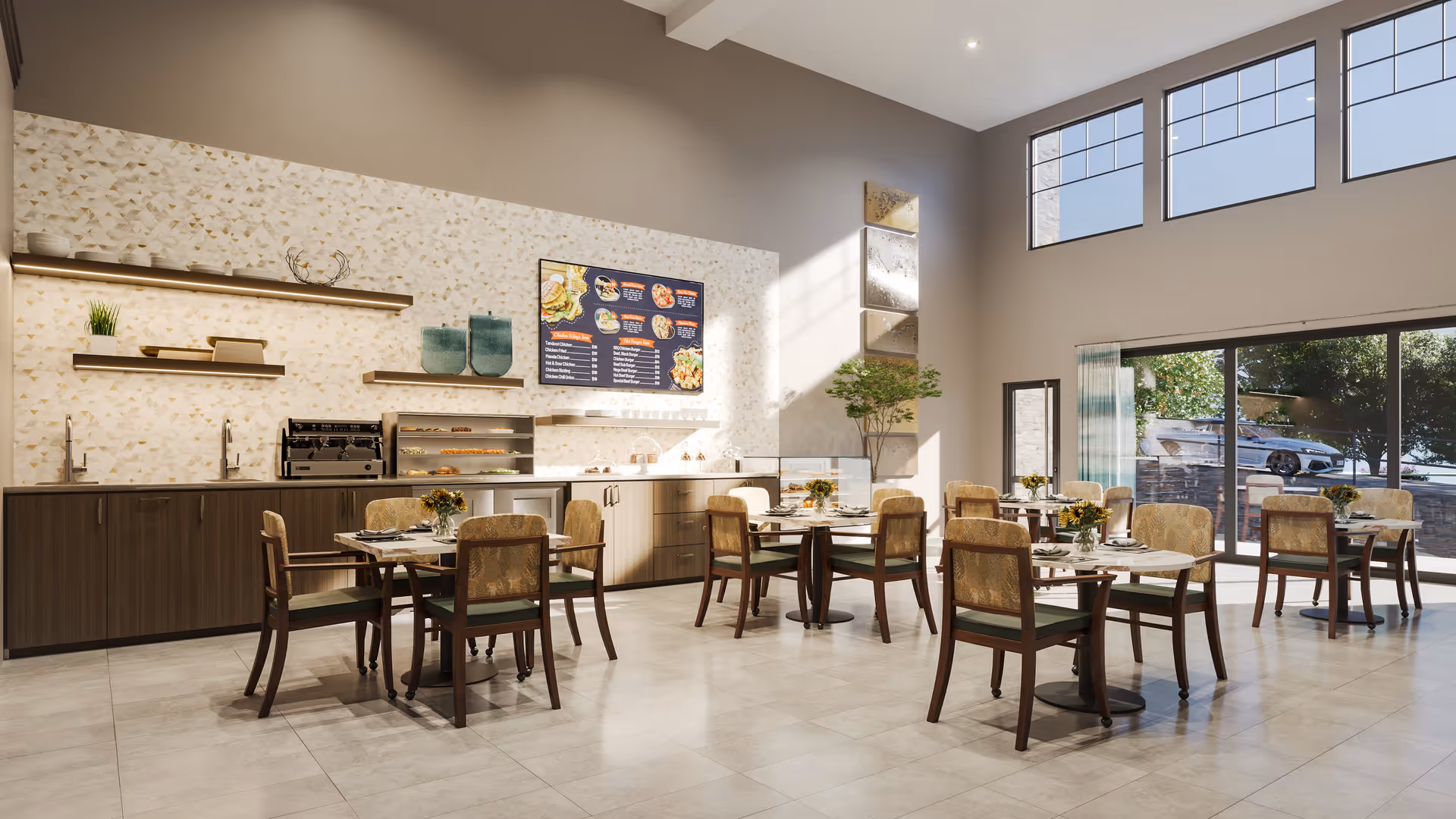 A bright and spacious dining area with several tables and chairs arranged neatly. The room features large windows allowing natural light to fill the space. There is a counter along one wall with shelves holding decorative items and kitchen appliances. A menu board is mounted on the wall above the counter. The floor is tiled, and there are small flower arrangements on each table.