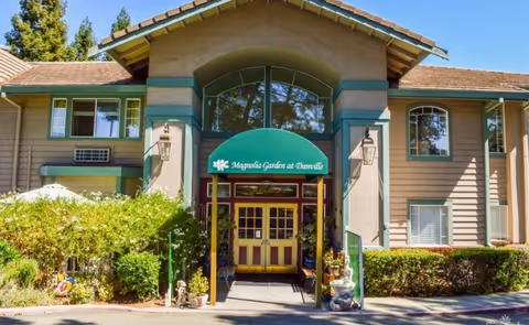 Front view of Magnolia Garden Assisted Living entrance with green canopy.