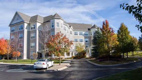 Atria Park of Ann Arbor exterior view of a multi-story senior living building with trees.