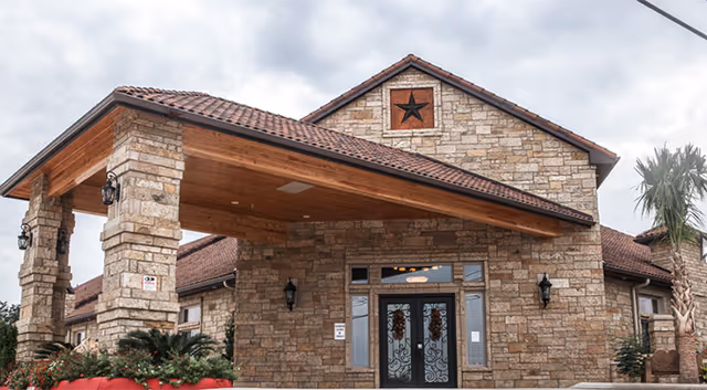 Stone brick entrance to Heritage Creek Assisted Living with a covered portico