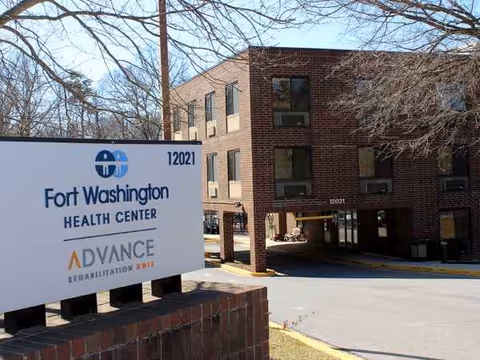 Brick Fort Washington Health Center building with a large sign in front of the entrance.