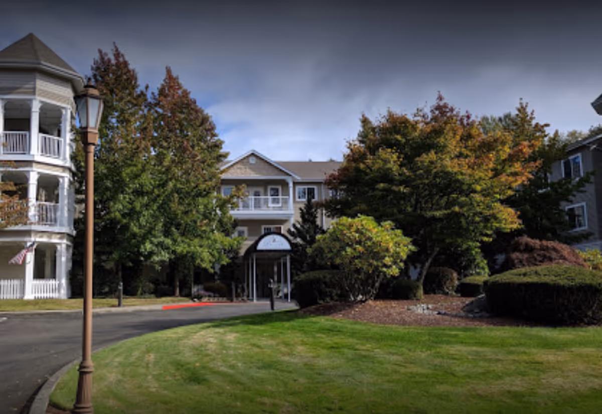 Front view of Bay Pointe by Cogir senior living building with trees and entrance.