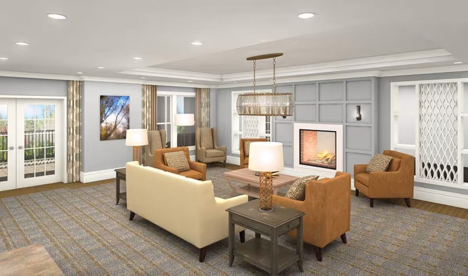 A spacious and well-lit living room in a senior living facility featuring a beige sofa, four brown armchairs, two side tables with lamps, a wooden coffee table, a fireplace with a modern gray paneled wall, large windows with patterned curtains, and double glass doors leading outside.