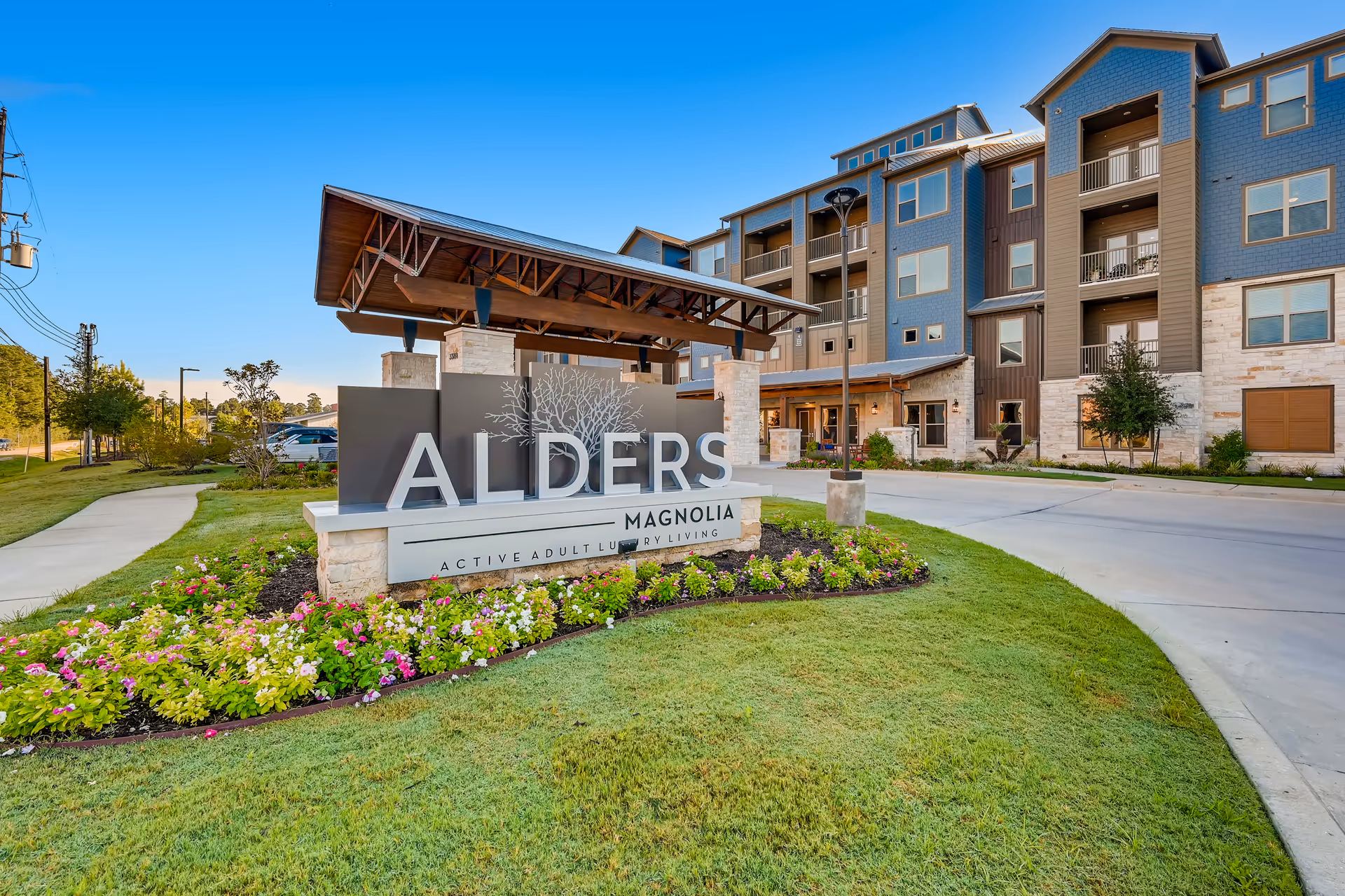 Exterior view of Alders Magnolia senior living facility with landscaping.