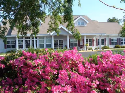 Front exterior of Sodalis Defuniak Springs with pink flowers in the foreground.