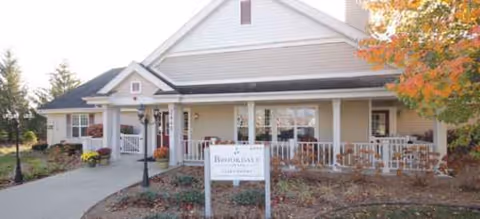Brookdale Saginaw exterior showing front porch, sign, and outdoor seating.